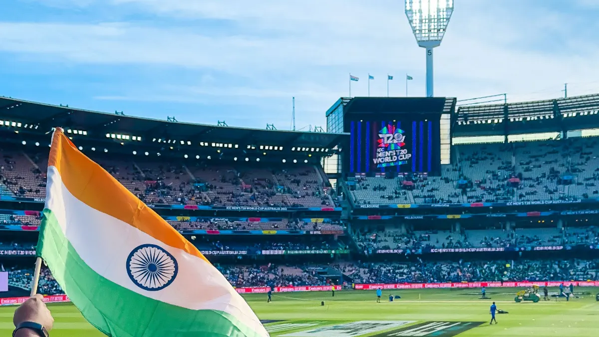 Indian cricket fans waving the flag in a packed stadium – Mahakal Book online cricket betting